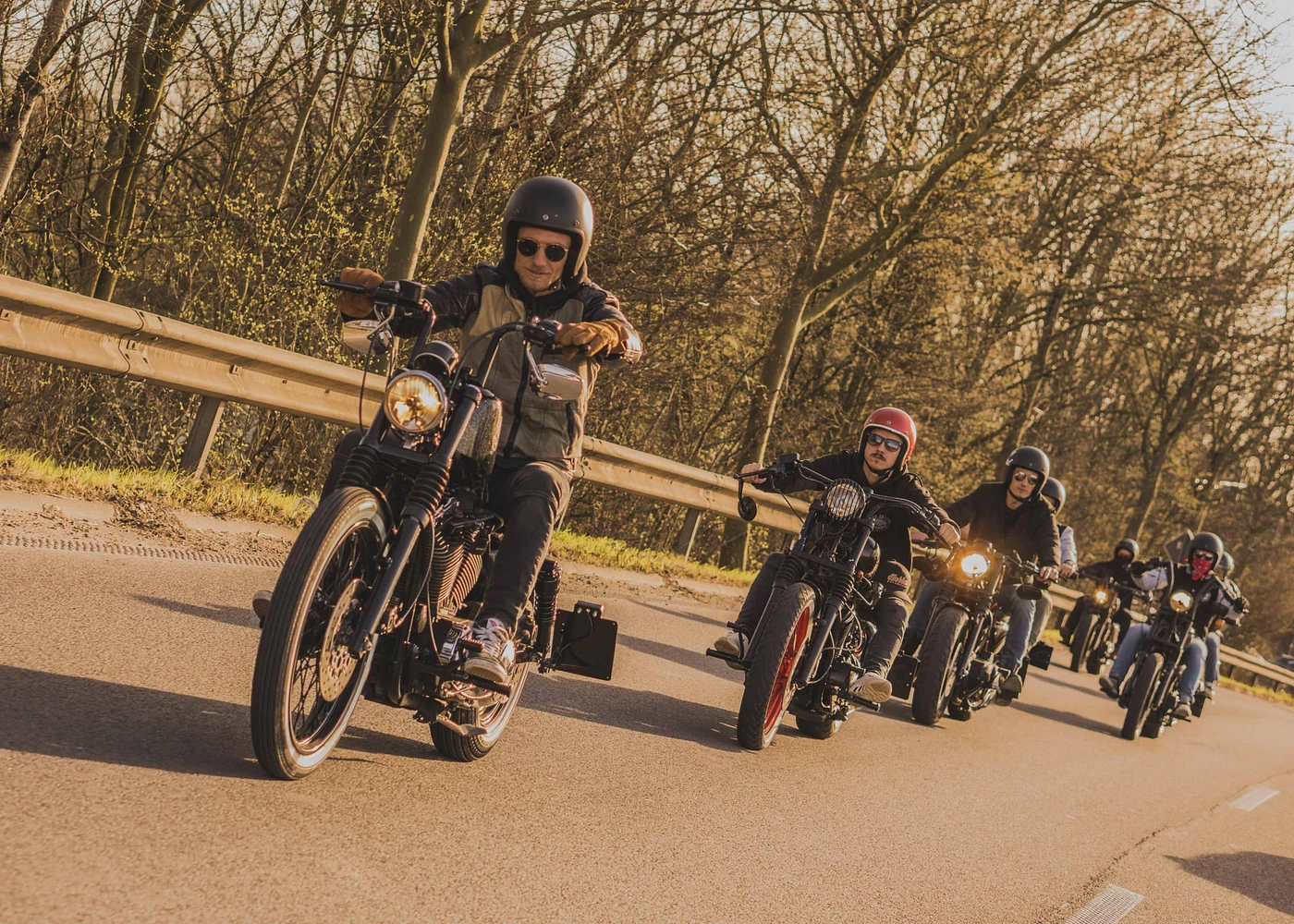 Bobber Brothers group ride on the open road at golden hour
